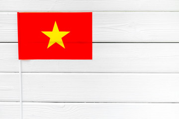 National day of Vietnam concept with flag on white wooden background top view