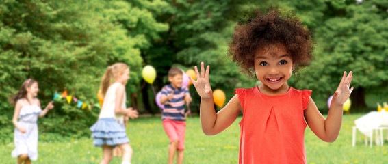 childhood and people concept - happy little african american girl over birthday party at summer park background