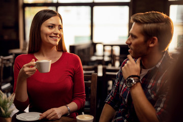 Happy woman enjoying on a date in a cafe.