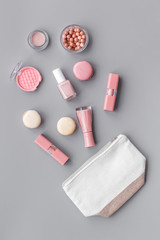 make-up accessories and fashion stylish cosmetics on gray desk background top view pattern