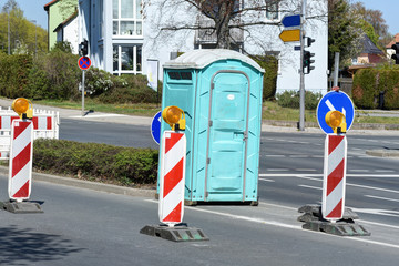 portable toilet in the middle of the road