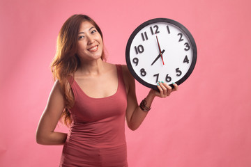 Young Asian woman with a clock.