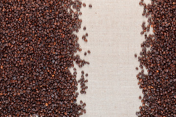 Roasted coffee beans on linea canvas with space on the right.