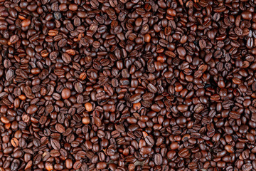 Roasted coffee beans close up from above.