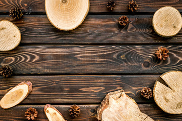 wooden sawcut and pine cone frame for blog on rustic background top view mockup