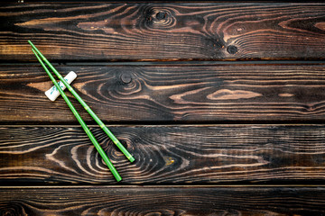 Japanese food cooking set with bamboo sticks for sushi on wooden background top view copy space