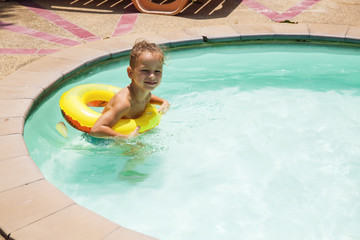 Baby boy is swimming in the pool 