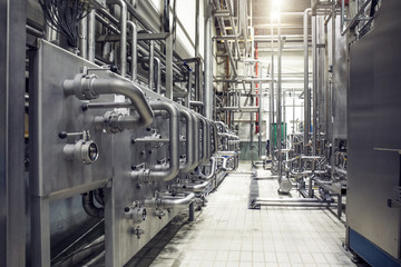 Stainless steel pipes and reservoirs or tanks, industrial beer production, metal pipeline in brewery fermentation and distillation process as abstract industrial background
