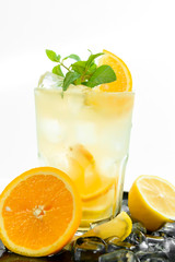 orange juice with ice and mint isolated on white