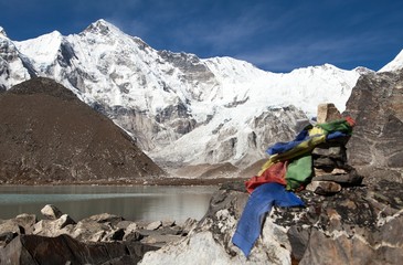 Mount Cho Oyu and stone pyramid with prayer flags