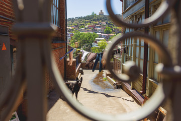 View on old part of Tbilisi through the fence and yard. Tbilisi, Georgia.