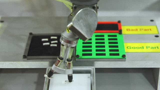 Automatic robot arm sorting microchips in factory