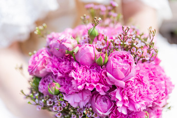 Bridal bouquet with pink and lilac roses. Traditional floral composition for wedding ceremony.