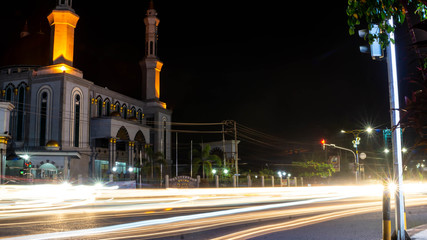 Fototapeta na wymiar Samarinda Islamic center at nigh, with light trails of traffic
