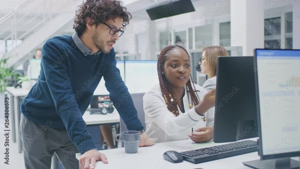 Poster in the busy corporate office: manager talks to businesswoman who works on desktop computer. business