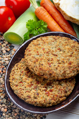 Tasty vegetarian food, raw burgers made from lentils legumes with vegetables ready for cooking