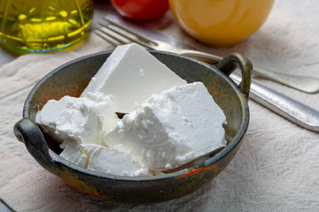 Fresh young soft white Feta cheese in bowl
