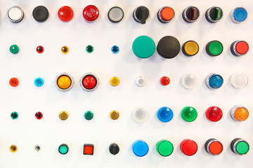 background of colored buttons and lights. buttons and light bulbs of different shapes and colors on...