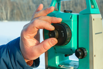 geodetic equipment is ready to work. the surveyor takes measurements. the hand of the surveyor sets...