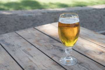 View of Cold Beer on Wooden Table in a Clear Day
