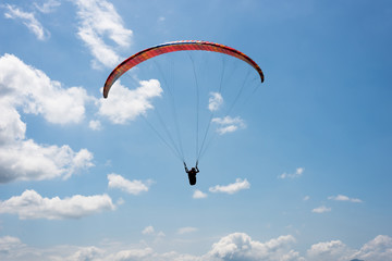 colorful paragliding under blue sky