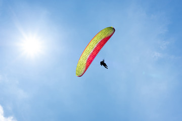 colorful paragliding under blue sky