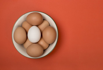 Eggs in plate on a red background.