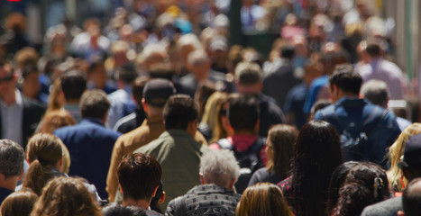 Crowd of people walking busy street in New York City