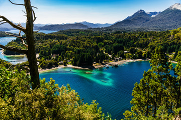 Obraz premium Scenic aerial nature colorful landscape photo of blue aquamarine lakes, rivers, Andes mountains, and green tree forest in Patagonia, Argentina