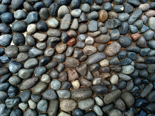 Gravel floor texture background. Floor background with stones. Rocks on the path for health. Round stone floor background.