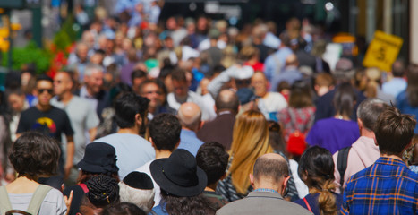 Crowd of people walking busy street in New York City