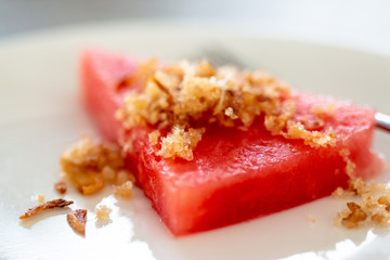 Fried dried fish with watermelon, which grilled fish into dry powder before seasoning with fried fish and fried shallots. A Thai food that is used to beat the heat in the summer.