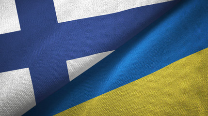 Finland and Ukraine two flags textile cloth, fabric texture