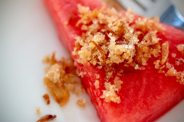 Fried dried fish with watermelon, which grilled fish into dry powder before seasoning with fried fish and fried shallots. A Thai food that is used to beat the heat in the summer.