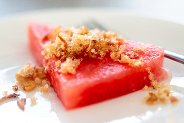 Fried dried fish with watermelon, which grilled fish into dry powder before seasoning with fried fish and fried shallots. A Thai food that is used to beat the heat in the summer.