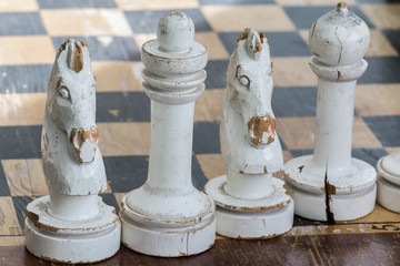 White wooden pieces on chess table.