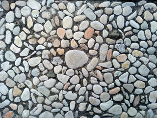 Gravel floor texture background. Floor background with stones. Rocks on the path for health. Round stone floor background.