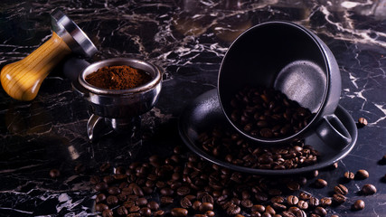 coffee cup and grinder on black marble table