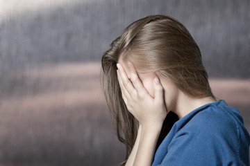 Fototapeta premium Young woman crying on background