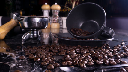 coffee cup, grinder and beans on black marble table