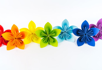 Origami kusudama flower stands in a row against a white background. Rainbow color. Diy Paper craft