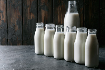 Fresh milk in different glass bottles