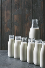 Fresh milk in different glass bottles