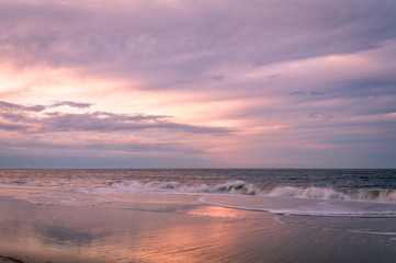 Fototapeta na wymiar Beautiful calming sunrise at Cape May Lighthouse, NJ, in early spring, Atlantic Ocean