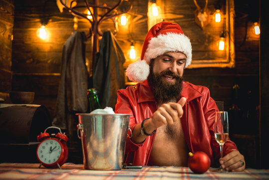 Brutal santa claus. Man bearded hipster santa with red hat celebrate with champagne drink. Christmas holiday. Lonely on christmas eve. Happy new year. Time to drink. Manly brutal santa leather jacket
