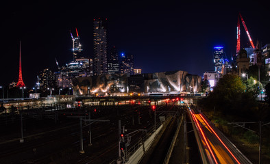 Fototapeta na wymiar Melbourne Skyline at night with moving train