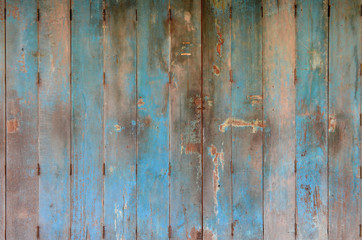 Old and dirty blue wooden door. Wooden door background texture. Wall and door decoration and design.