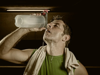young attractive and handsome sport man at fitness club sweating after workout hard training...