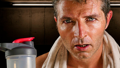 young attractive and handsome sport man at fitness club sweating after workout hard training...