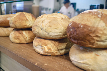 Baker at Whole Foods bakery baking bread